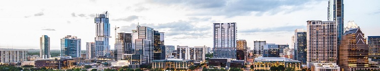 The skyline of the city of Houston, showing tall buildings and water.