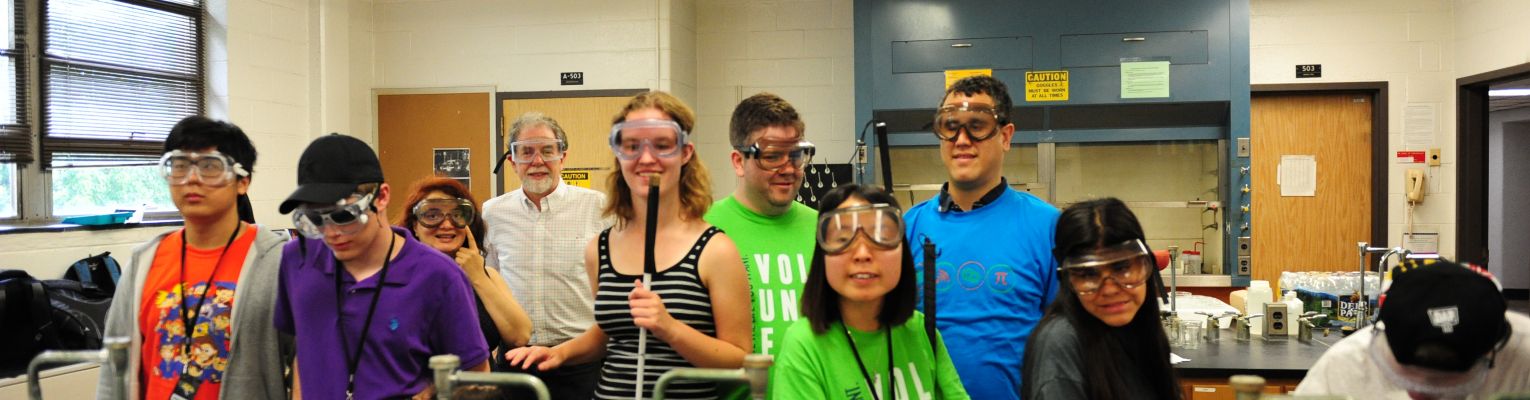 A group of blind students in a science lab poses for a picture.