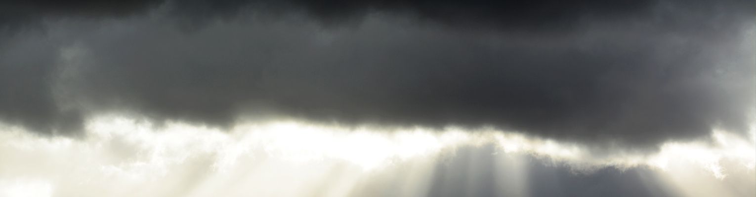 dark clouds with sun shining through