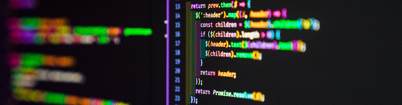 Website code in multiple colors against a black background.