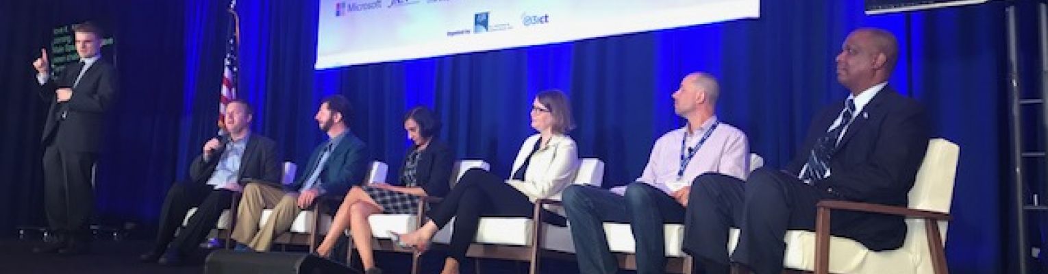 A group of panelists including NFB Executive Director of Blindness Initiatives, Anil Lewis, sit on a stage at M-Enabling 2017.