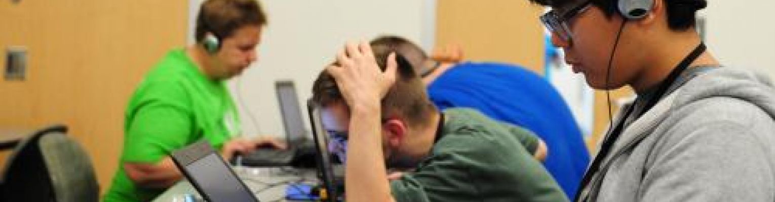 Students at NFB Youth Slam work on laptops.